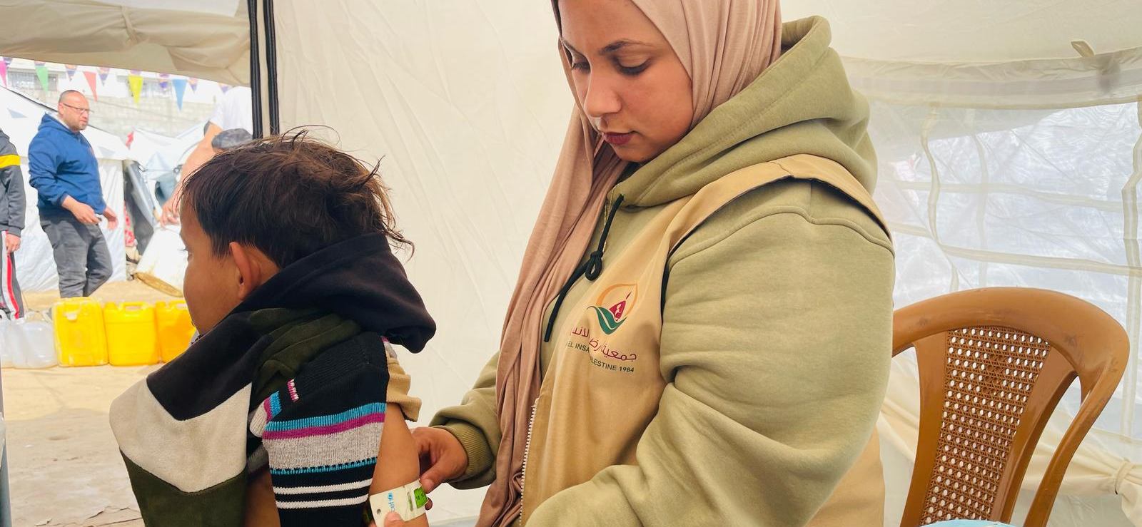 Fotografía de mujer ayudando a un niño en Gaza